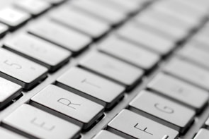 Close-up of hands typing an email on a modern keyboard with Silverseal Supply branding visible.