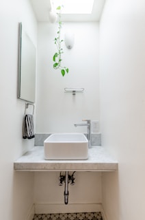 white ceramic sink with faucet