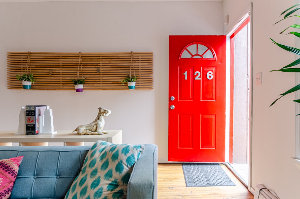 red wooden door near gray and white sofa