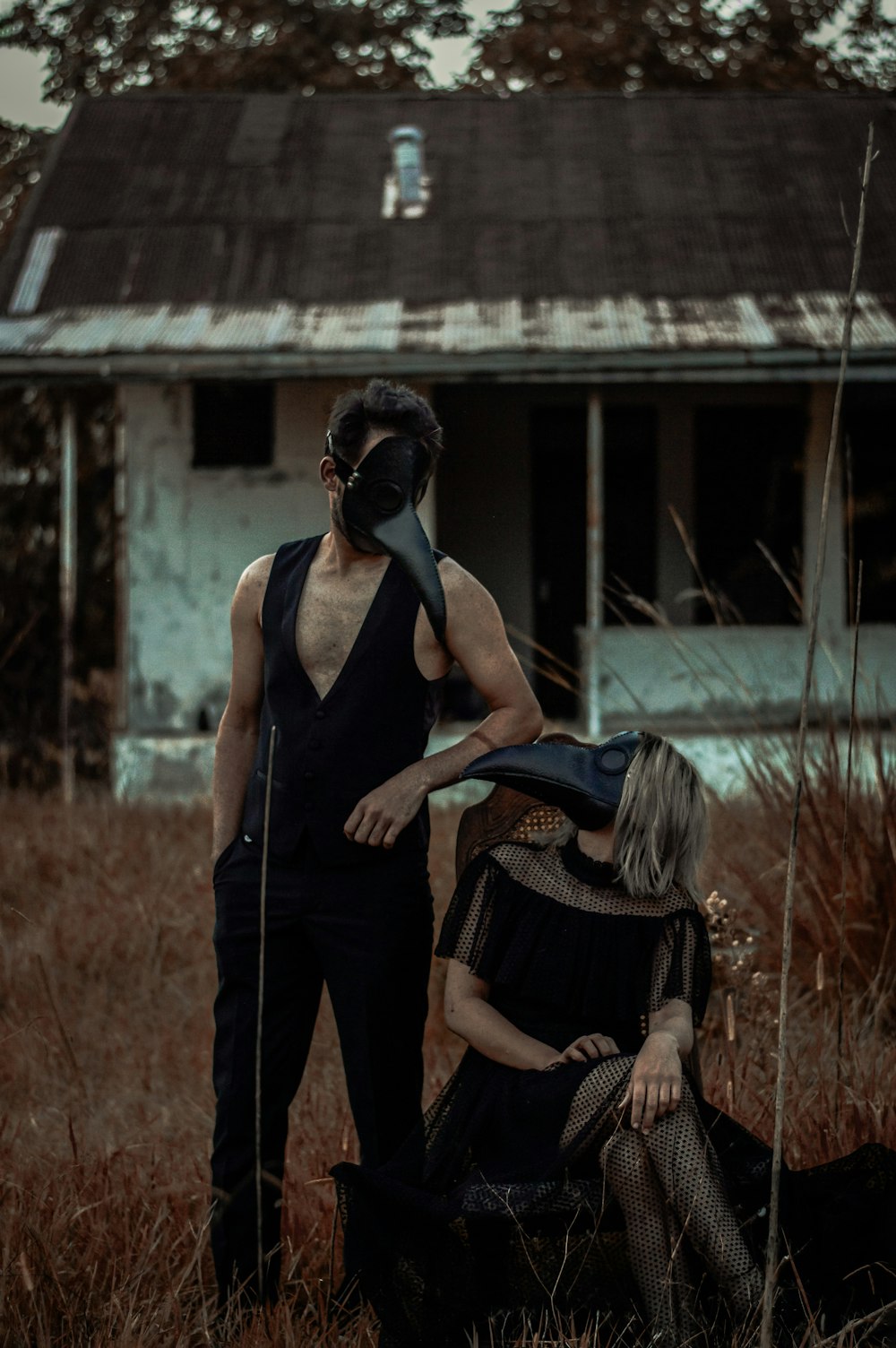 woman in black tank top and black pants standing on brown grass field during daytime