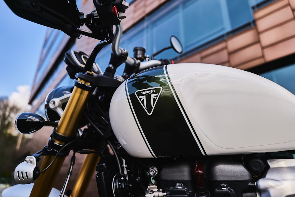 black and white motorcycle near blue wall