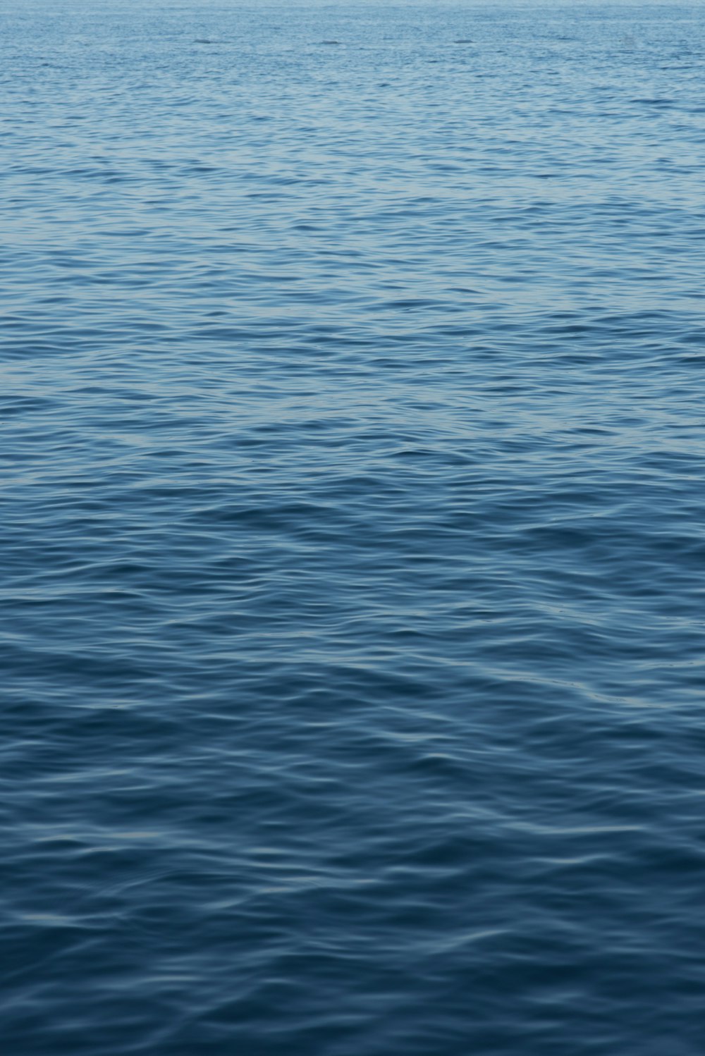 a large body of water with a boat in the distance