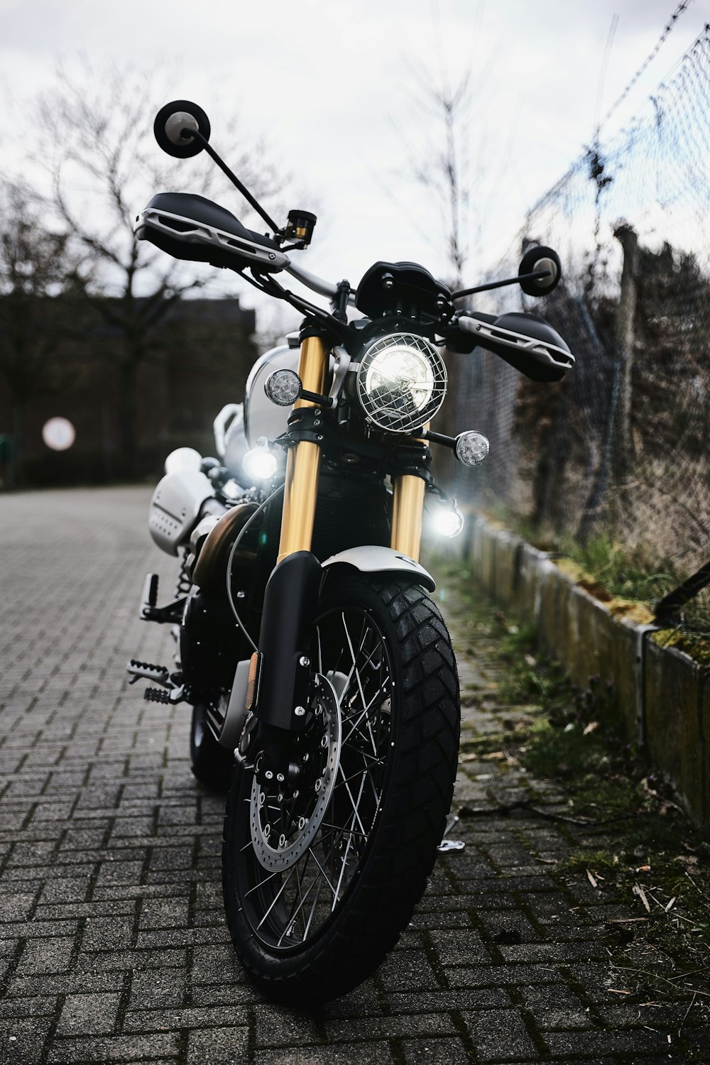 black and yellow motorcycle parked on sidewalk during daytime