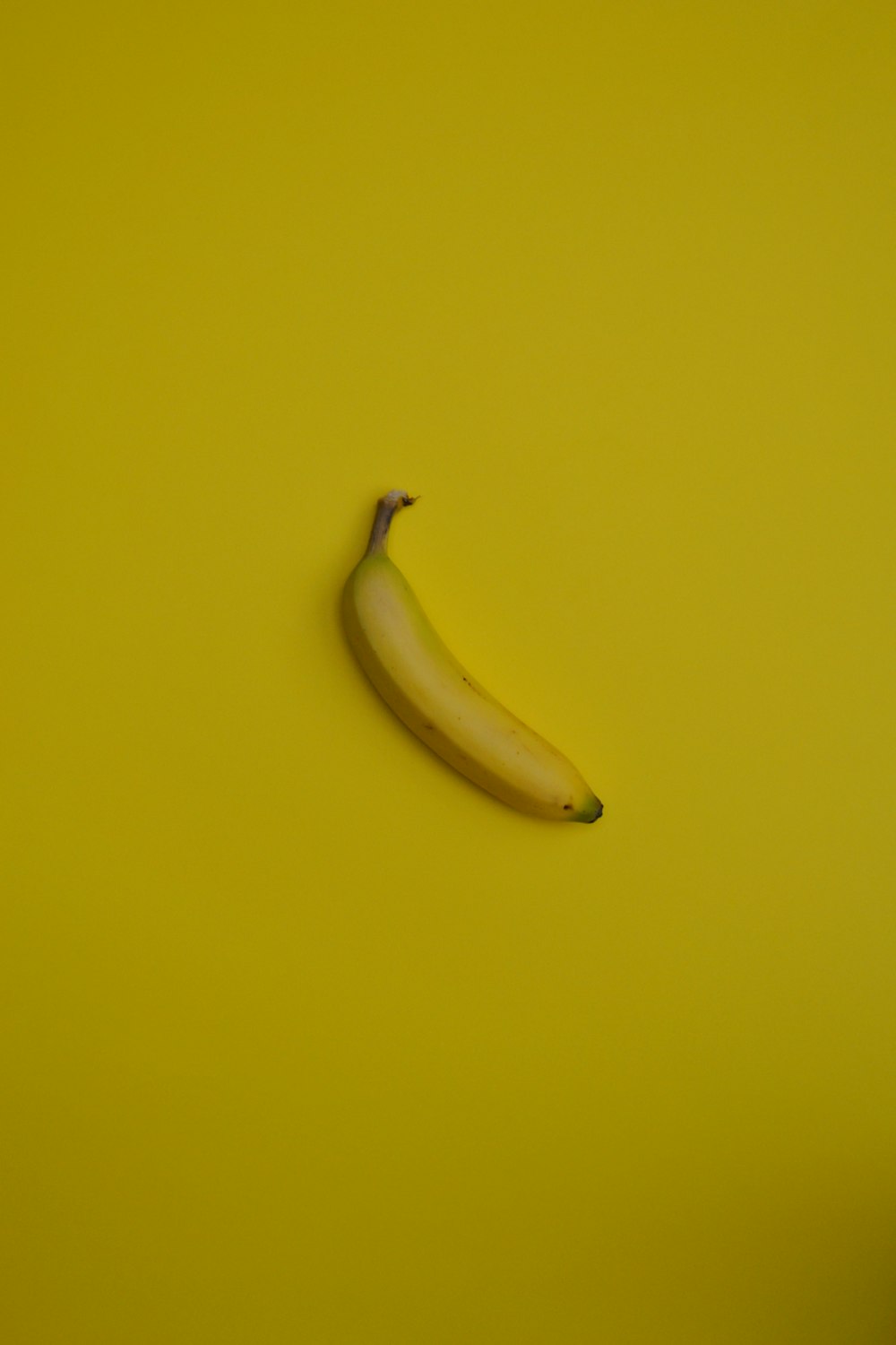 yellow banana fruit on yellow surface