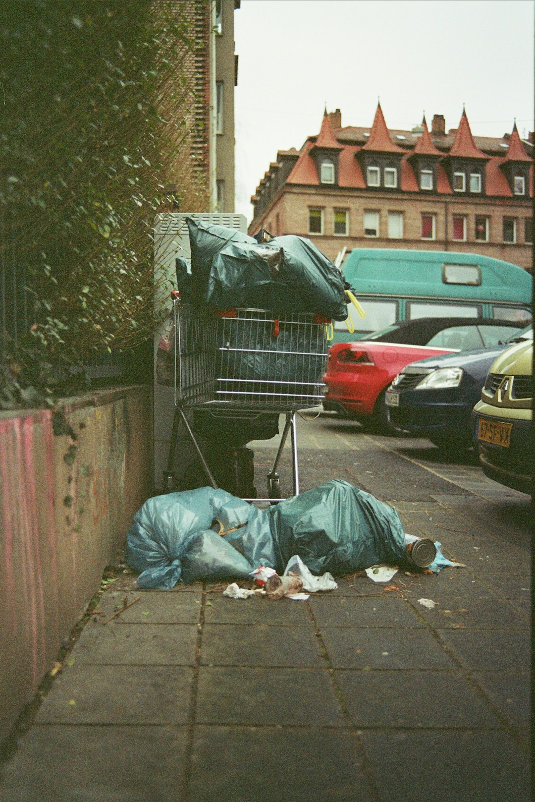  black car parked beside building during daytime dustbin