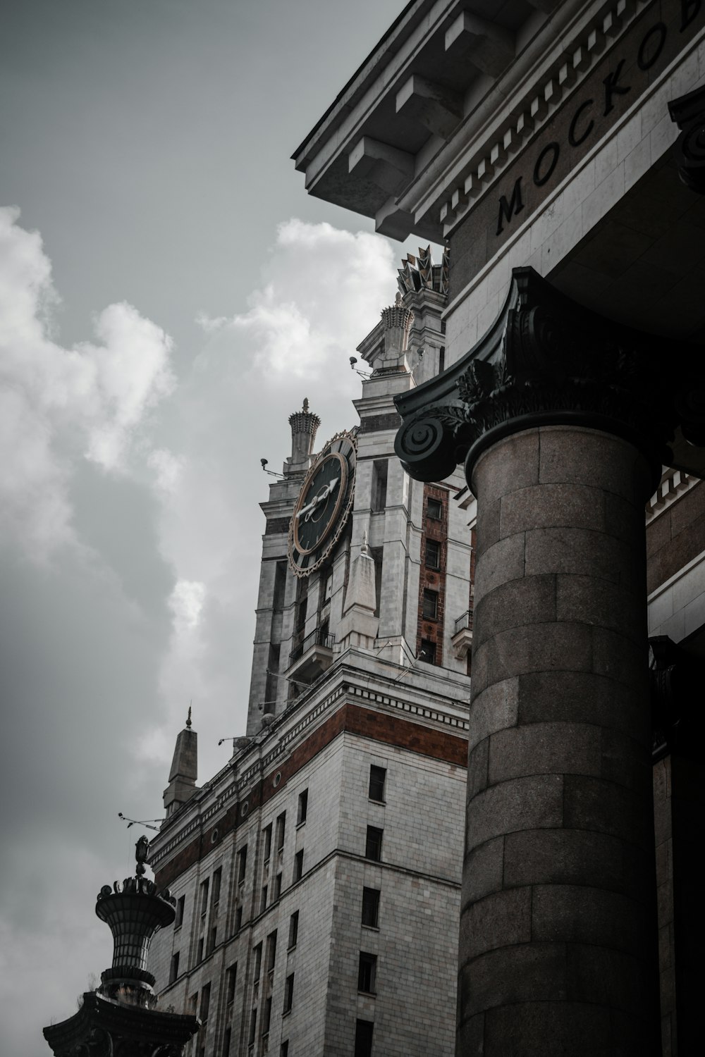 brown and white concrete building under white clouds during daytime