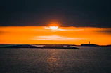 Sunset view over the iconic Touros lighthouse with vibrant orange sky