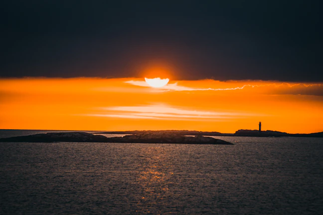 Sunset view over the iconic Touros lighthouse with vibrant orange sky