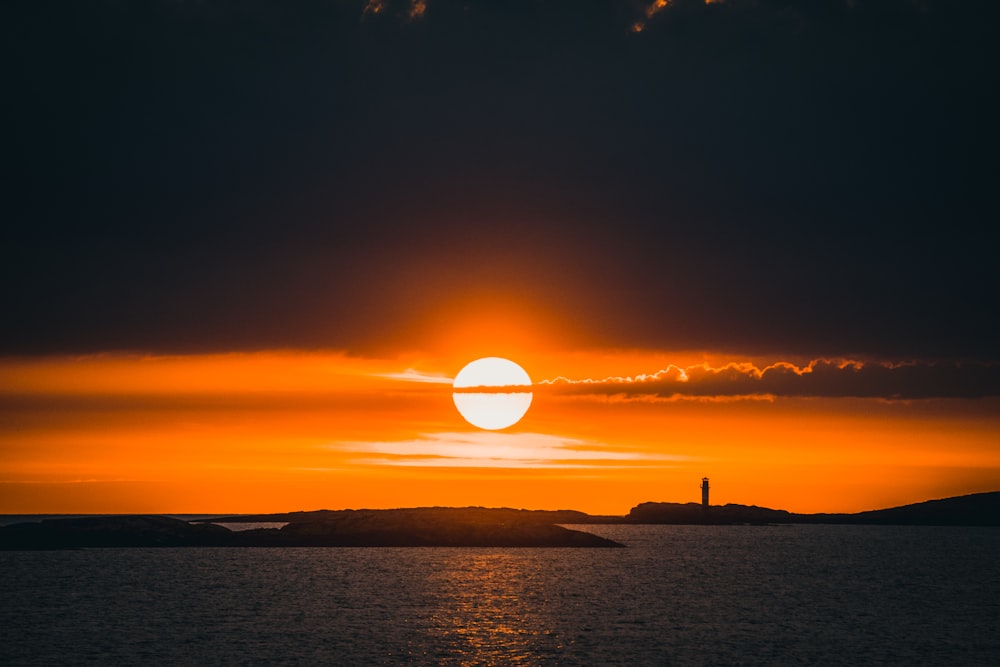 silhouette of person standing on beach during sunset