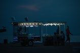 a food cart sitting on the side of a body of water
