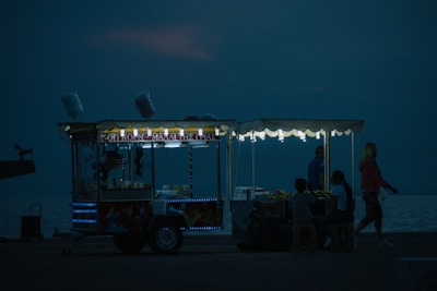 a food cart sitting on the side of a body of water