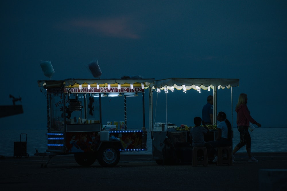 a food cart sitting on the side of a body of water