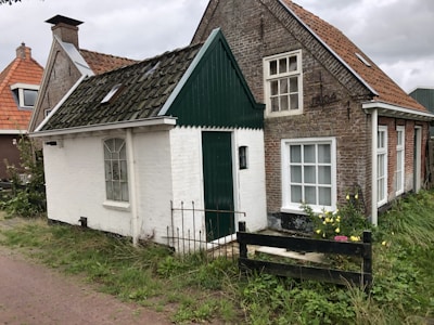 Front view of a cozy anticrético house with a small garden and bright windows.