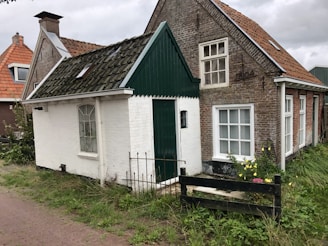 Front view of a cozy anticrético house with a small garden and bright windows.