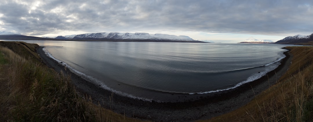 body of water under cloudy sky during daytime