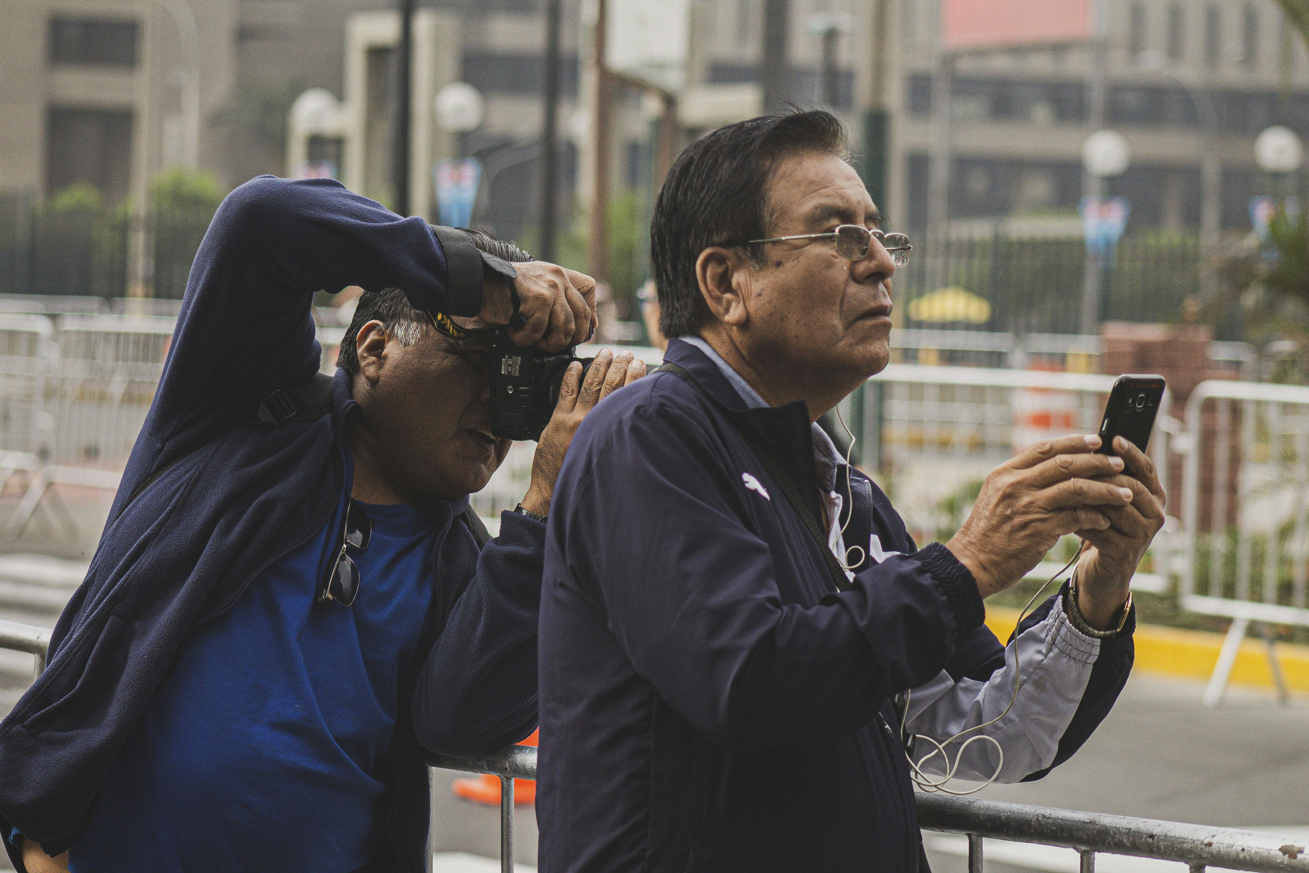 man in blue jacket standing beside man in black jacket