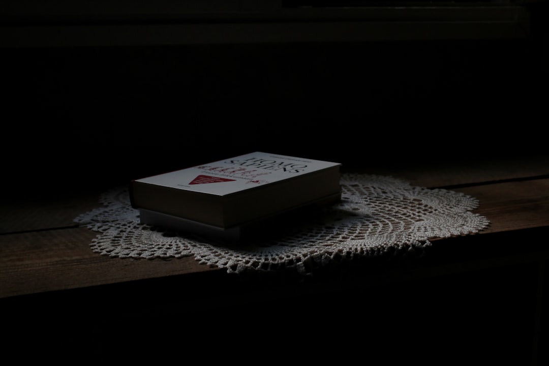 white and red marlboro cigarette pack on white table cloth