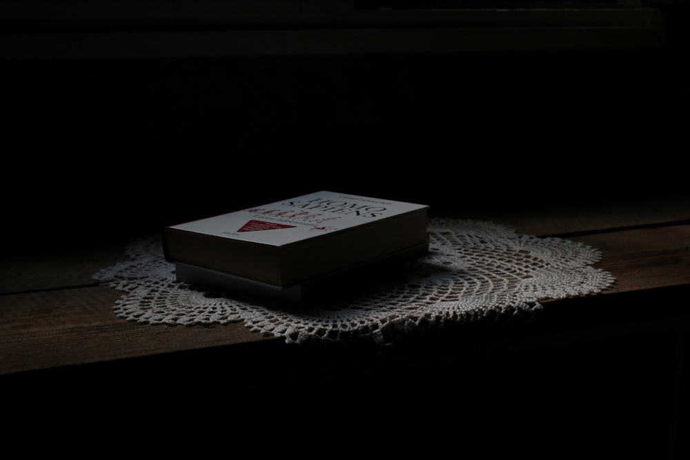 white and red marlboro cigarette pack on white table cloth