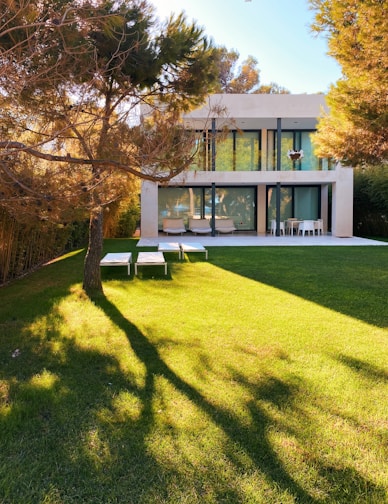 white and brown concrete building near green grass field during daytime