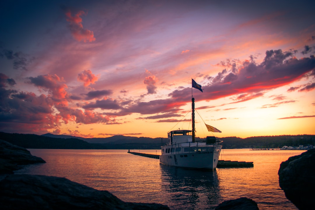 white boat on sea during sunset