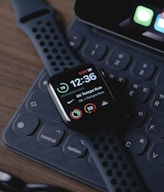 black smart watch on black computer keyboard