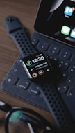 black smart watch on black computer keyboard