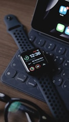 black smart watch on black computer keyboard