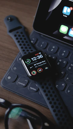 black smart watch on black computer keyboard