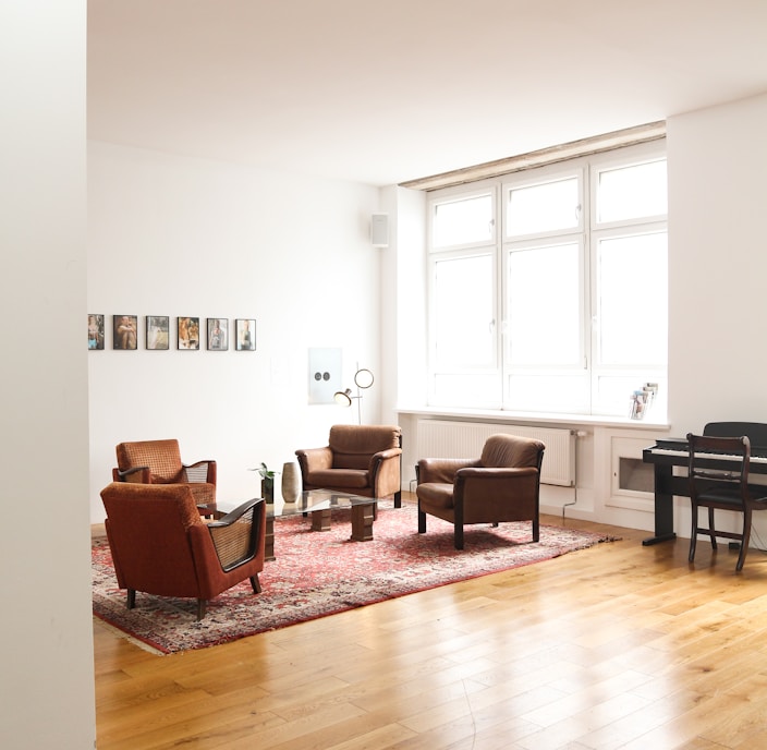 living room with brown wooden parquet floor and white wall