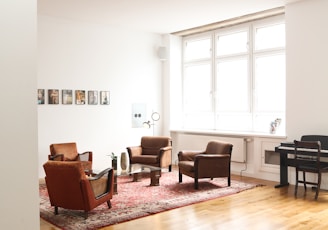 living room with brown wooden parquet floor and white wall