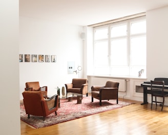 living room with brown wooden parquet floor and white wall