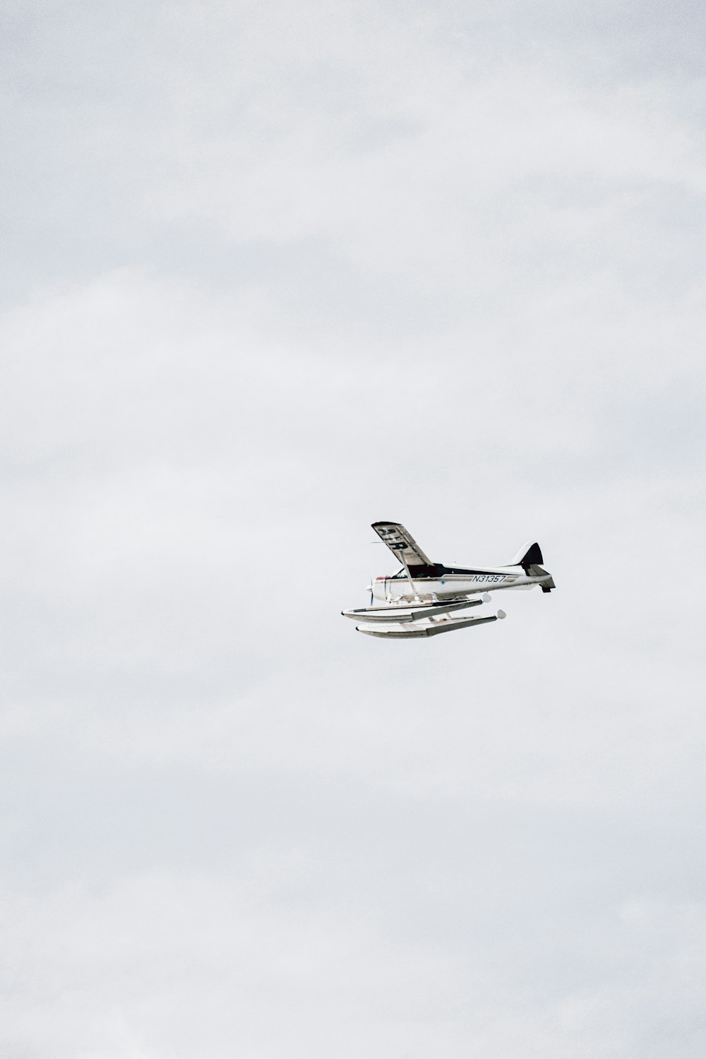 white and black airplane flying in the sky