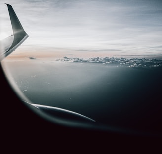 airplane window view of clouds during daytime