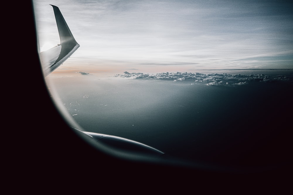 airplane window view of clouds during daytime