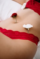 woman in red lace panty lying on bed
