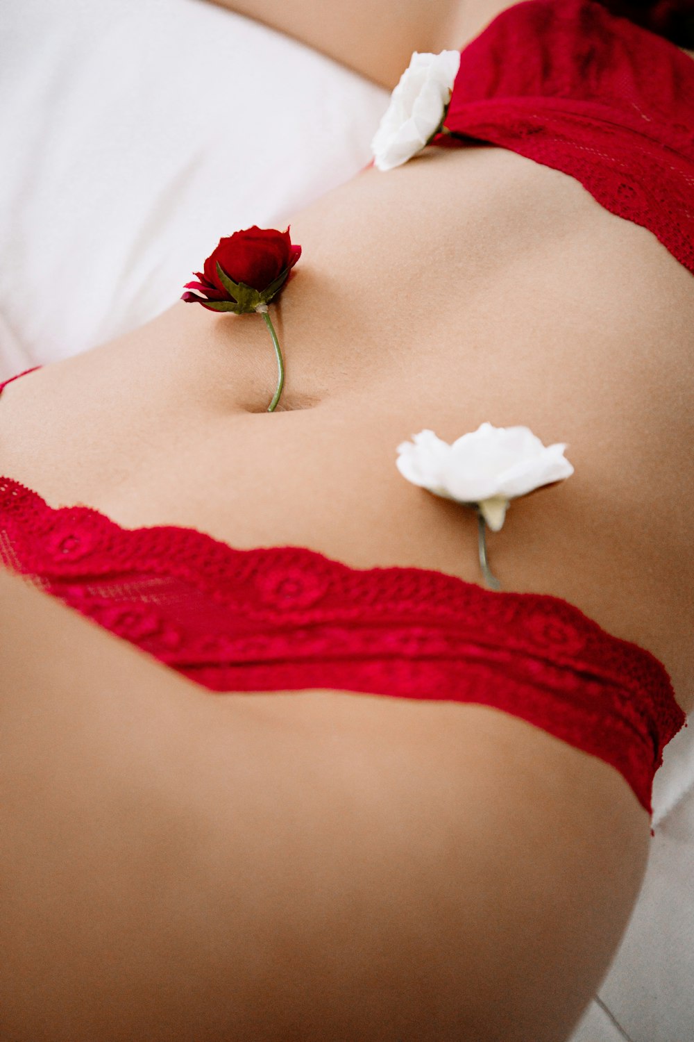 woman in red lace panty lying on bed