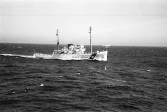 Coast guard vessel speeding through choppy waters