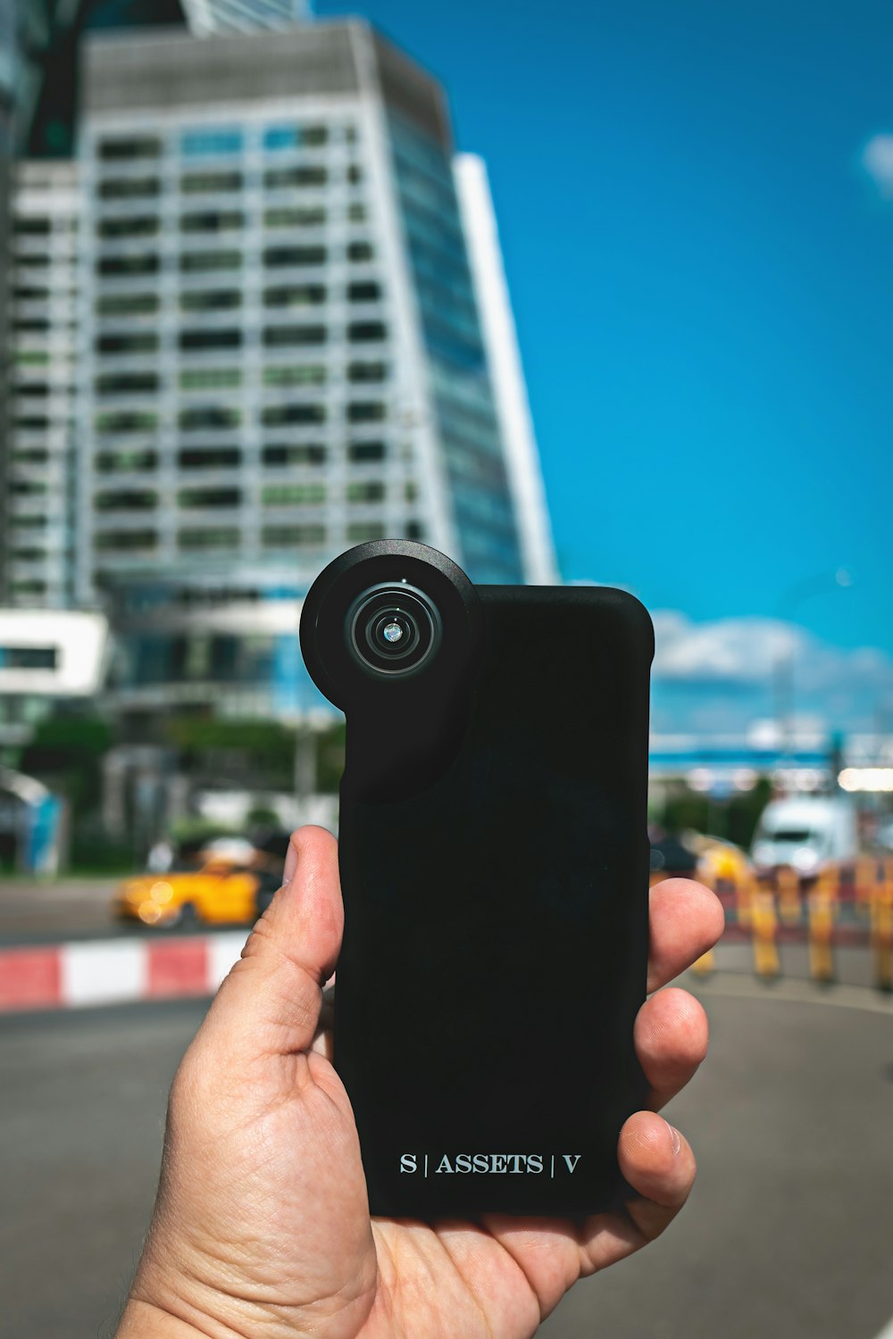 person holding black camera lens