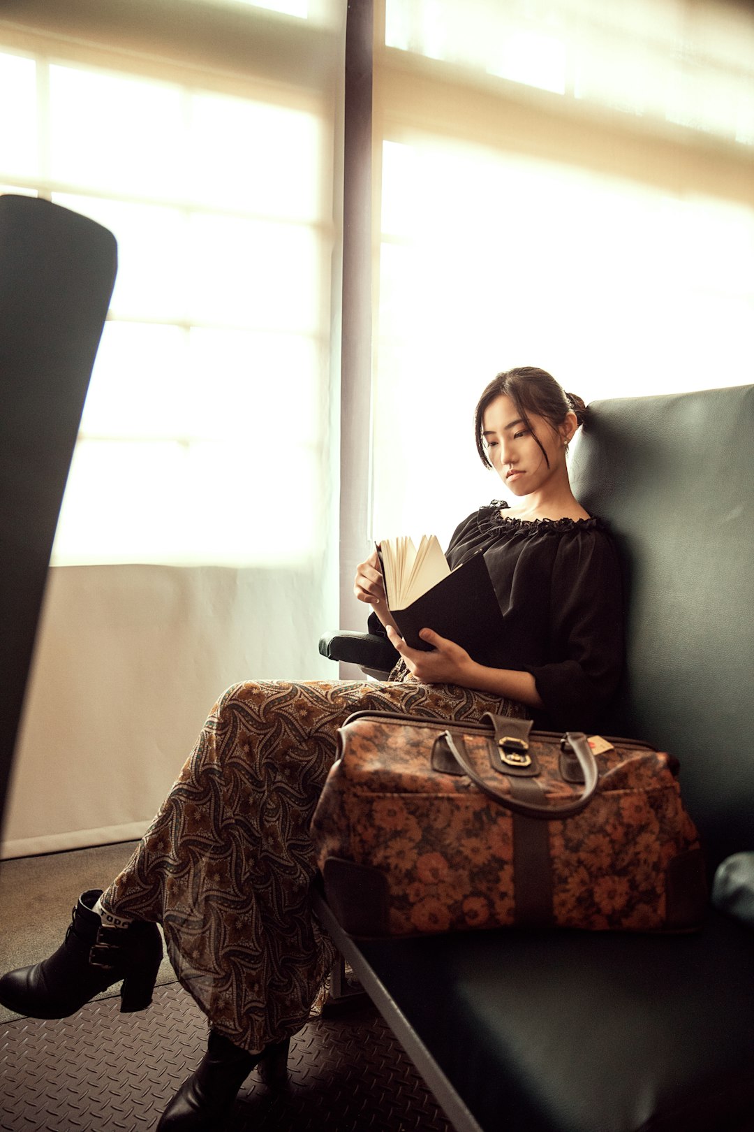 woman in black long sleeve shirt sitting on black sofa