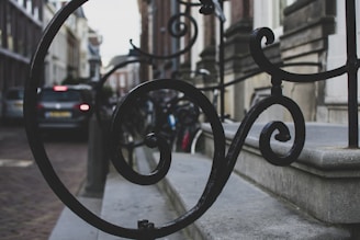 Close-up of decorative wrought iron work on a modern building facade.