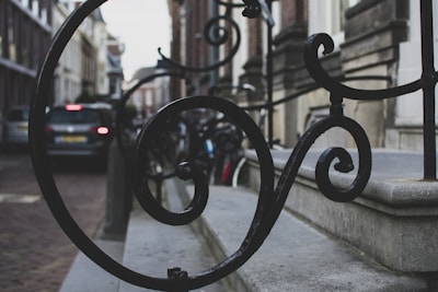 Close-up of decorative wrought iron work on a modern building facade.