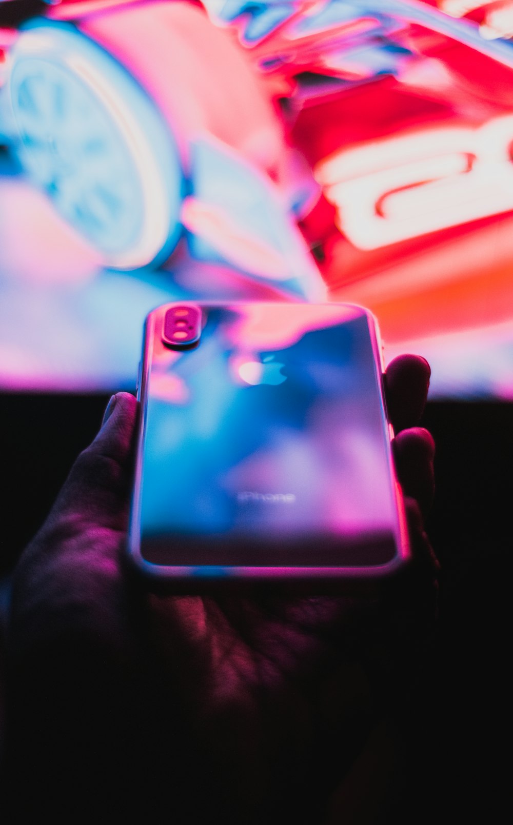 person holding iphone with blue case