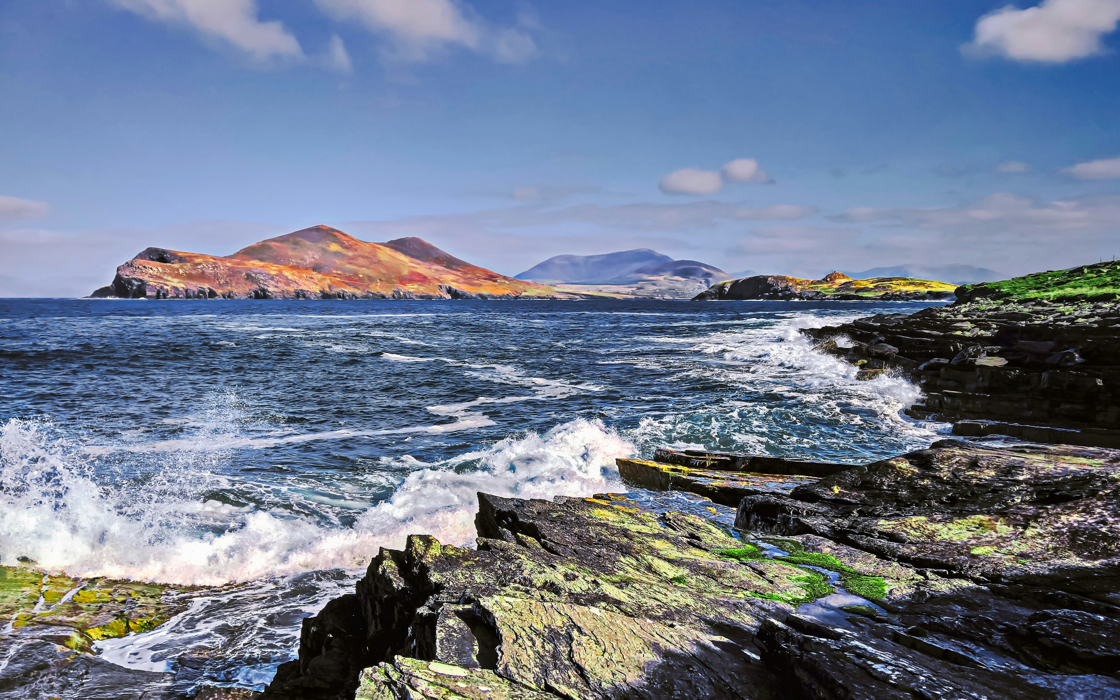 ocean waves crashing on rocks under blue sky during daytime