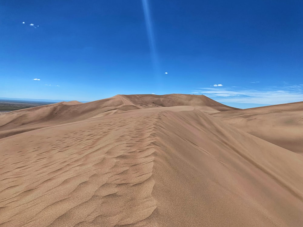 brown sand under blue sky during daytime