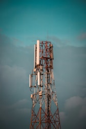 A close-up of a telecom antenna tower against a clear sky.
