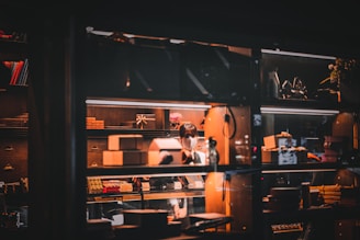 A cozy workspace with artisan hands carefully assembling a stylish, unique gift box surrounded by natural materials and soft lighting.