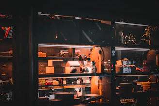 A bright, cozy workspace filled with colorful packaging boxes stacked neatly, showcasing various custom designs.