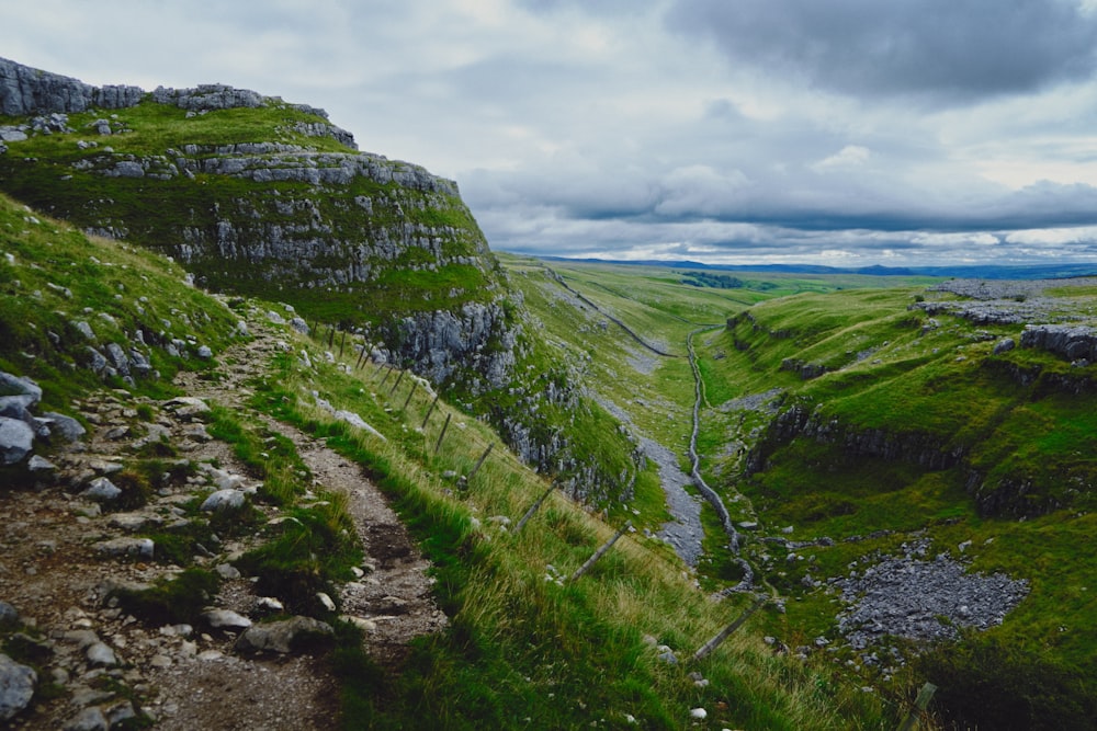 green and gray mountain under cloudy sky during daytime