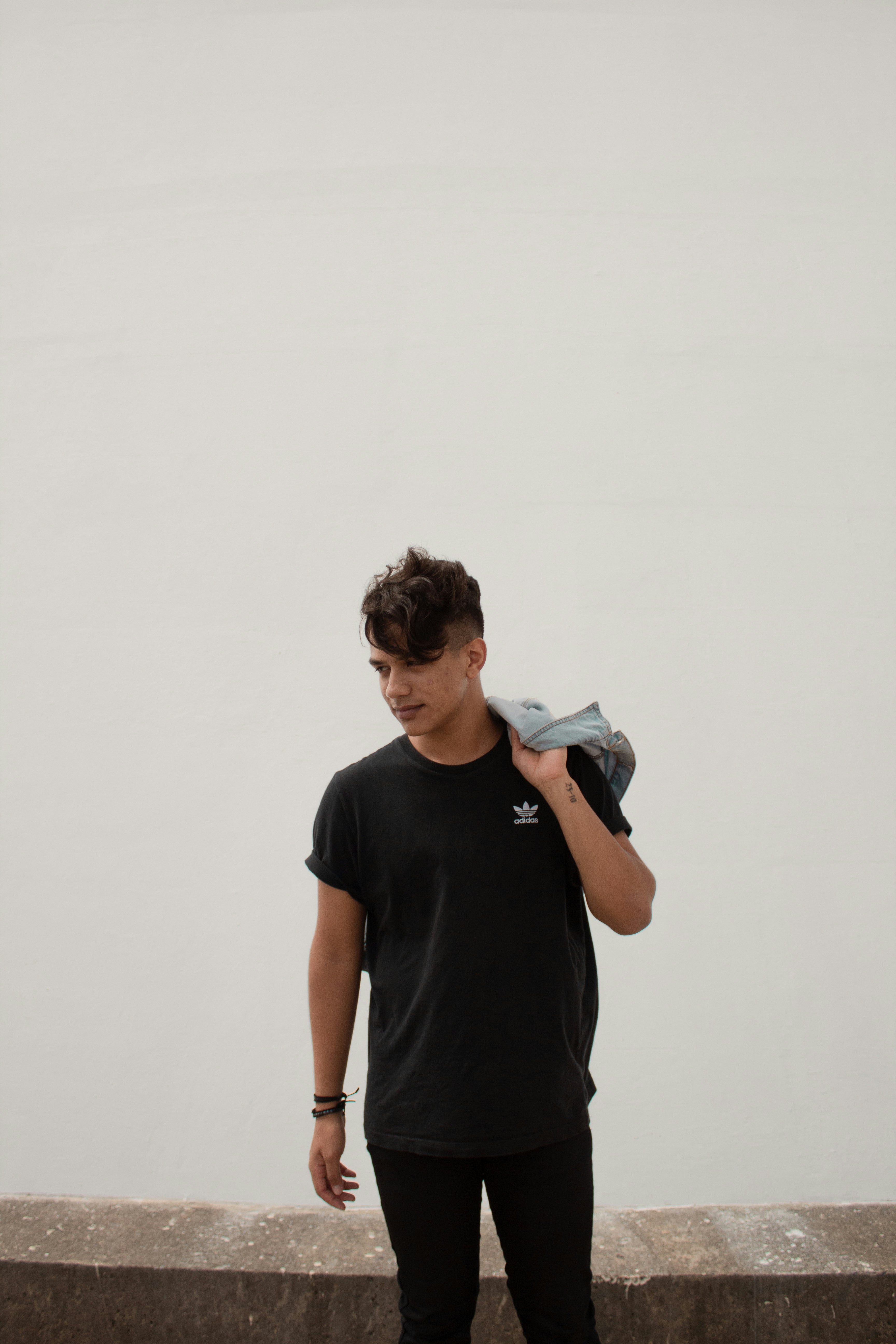 man in black crew neck t-shirt holding black smartphone