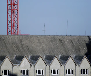 Two buildings connected by a focused wireless signal beam illustrating point-to-point WiFi.